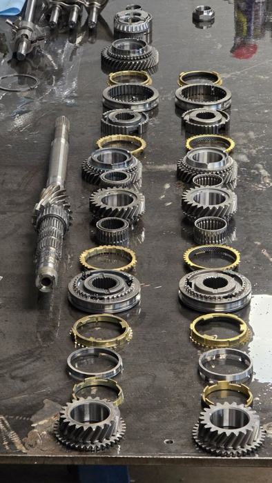 Transmission gears and synchros laid out on the bench